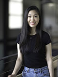 Headshot of Emeline Lee: she has long, straight, black hair and wears a black shirt and jeans.