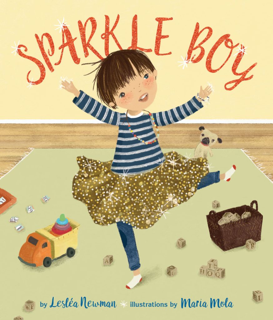 Cover of Sparkle Boy, showing a young boy dancing with a shiny gold ballet tutu (skirt) on, while a toy truck and some blocks are scattered around the floor.